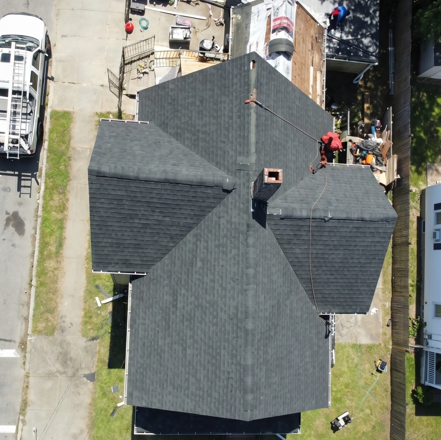 Aerial view of a newly installed dark architectural asphalt shingle roof on a Massachusetts home by Jennifer Construction